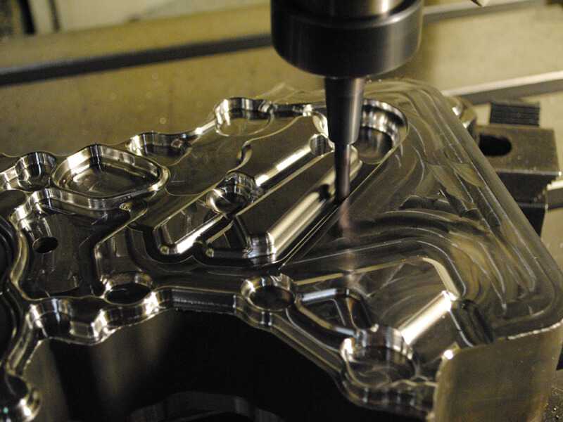 Screen shows hardened steel subinsert being machined on a high speed vertical CNC machine
